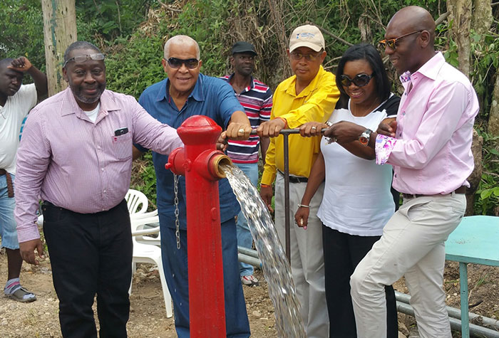 Minister of Water, Land, Environment And Climate Change Hon. Robert Pickersgill (2nd left), turns on the Cassava Pond water supply system in North West St. Catherine, during a commissioning ceremony on Thursday (October 22). Others (from left) are: Managing Director of the Rural Water Supply Limited (RWSL), Audley Thompson; Mayor of Spanish Town, Norman Scott; Commissioner at the RWSL, Debbie-Ann Kerr-Scott; and Councillor for the Lluidas Vale Division, Hugh Graham.